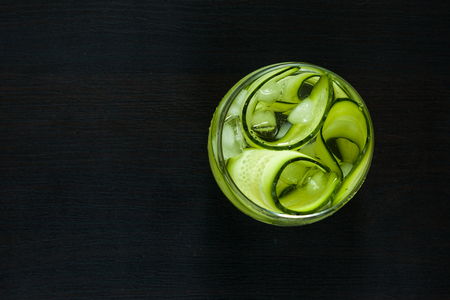 Glass of healthy diet drink with cucumber and ice. Top view.の写真素材