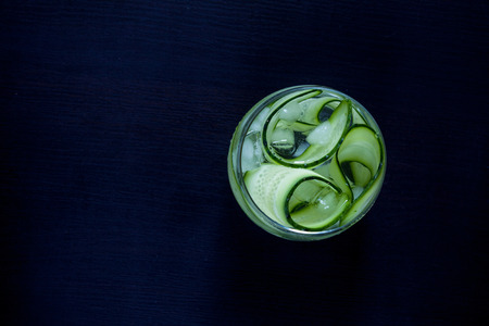 Glass of healthy diet drink with cucumber and ice. Top view.の写真素材
