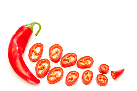 Sliced red hot chili peppers isolated on white background.の写真素材