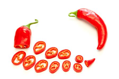 Sliced red hot chili peppers isolated on white background.の写真素材