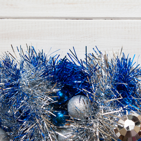 Blue and silver Christmas wreath with decorations on white woodenの写真素材