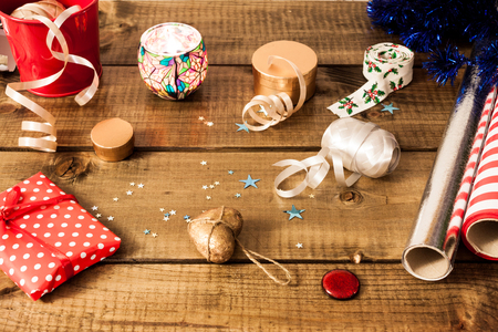 Packaging christmas gifts on dark woodenの写真素材