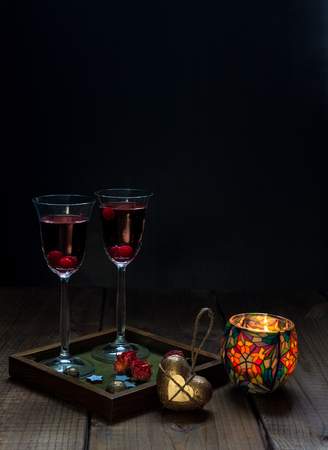 Still life with a candle and two glasses of red wine.の写真素材