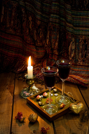 Still life with a candle and two glasses of red wine.の写真素材
