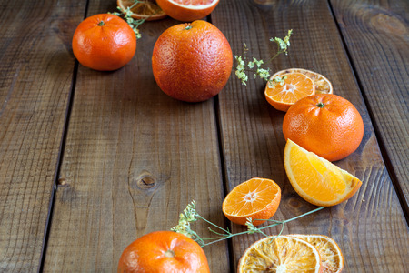 Ripe citrus fruits - oranges and tangerinnes, on rustic dark table.の写真素材