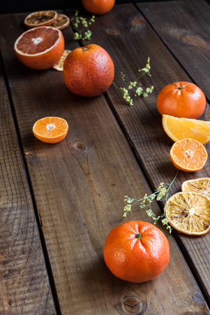 Ripe citrus fruits - oranges and tangerinnes, on rustic dark table.の写真素材