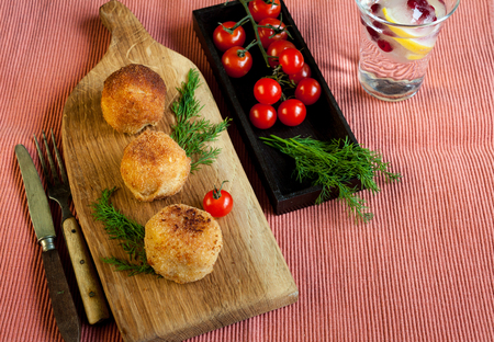 Potatoes croquets, tomatoes and dill on a rusticの写真素材