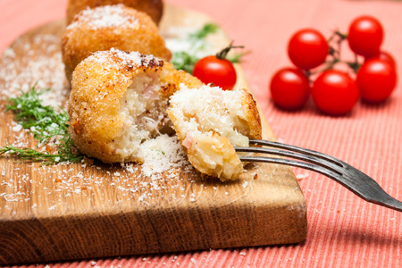 Potatoes croquets, tomatoes and dill on a rusticの写真素材