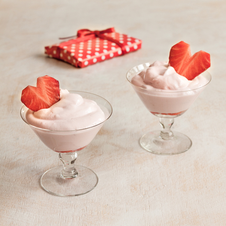Milk dessert in a glass with strawberry heart.の写真素材