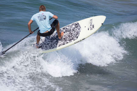 Pacific Beach, San Diego Revolt Summer Surf Series 6.0 08/17/2012 - Paddle Boarder Riding Waveのeditorial素材