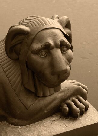 closeup of a stone lion head. sepia