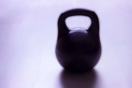Cast-iron two-pound weight on a blurred background copy space.の写真素材