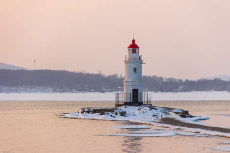 Tokarevsky lighthouse in Vladivostok at dawn on a winter morning.の写真素材