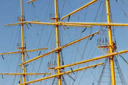 Rays, masts, cables and rigging of a sailing ship close-up.の写真素材