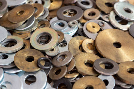 Steel and brass washers of various sizes and diameters.の写真素材