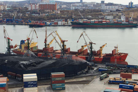 Vladivostok, Russia - April 20, 2019: Coal loading onto a bulk carrier in an open way at a coal...