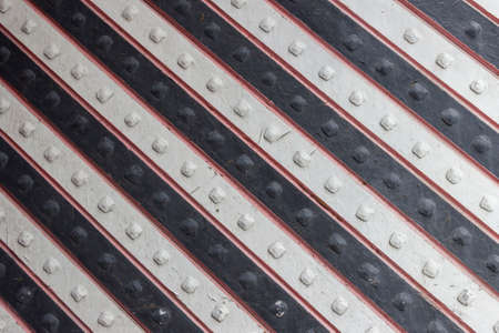 The gate is painted with alternating black and white stripes.