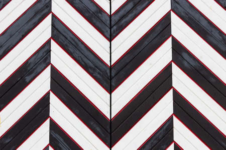 The gate is painted with alternating black and white stripes.