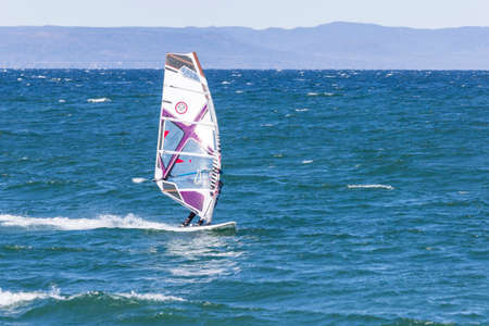 Vladivostok, Russia - October, 05, 2019: Windsurfers on the sea waves on a windy autumn day in the Amur Bay in Vladivostok.のeditorial素材