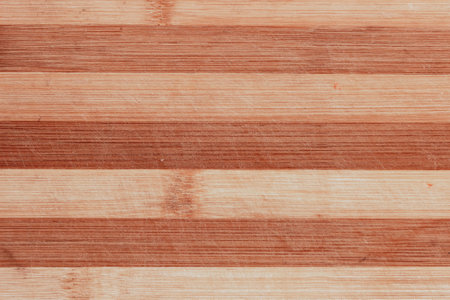 Surface of a striped wooden scratched kitchen chopping board.の写真素材