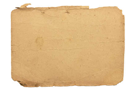 Isolate of an old shabby piece of cardboard with jagged, ragged edges and stained.の写真素材