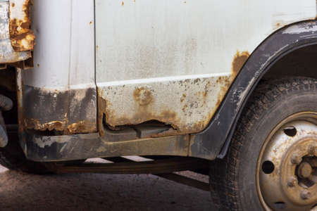 Rust on metal parts of the car body. Corrosion of cars as a result of deicing roads with chemical...