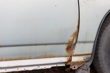 Rust on metal parts of the car body. Corrosion of cars as a result of deicing roads with chemical reagents in St. Petersburg.の写真素材