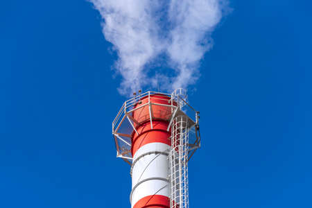 Smoke coming from the chimney of a thermal power plant in St. Petersburg. The use of natural gas in...