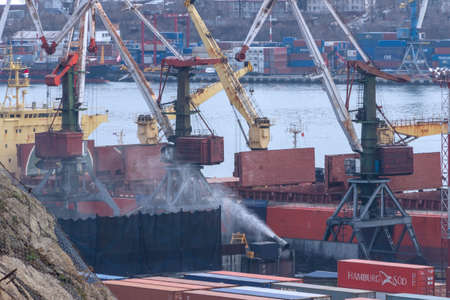 Vladivostok, Russia - April 20, 2019: Open-pit coal transshipment in the port of Vladivostok....
