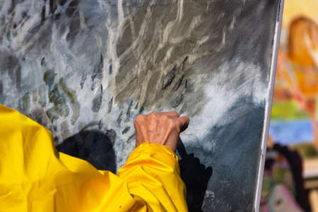 St. Petersburg, Russia - Sptember, 05,2021: The hand of a street artist painting a picture.のeditorial素材