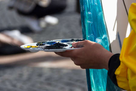 St. Petersburg, Russia - Sptember, 05,2021: The hand of a street artist painting a picture.のeditorial素材