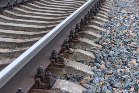 Bolts that attach railway rails to concrete sleepers. Railway fasteners in close-up.