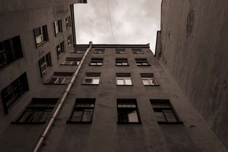 Walk-through courtyard in the center of St. Petersburg. Yellow walls of an old building.