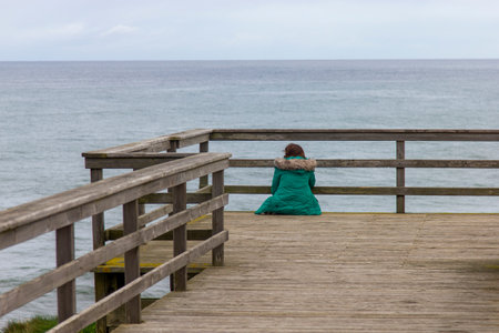 Woman from behind looking at seaの写真素材