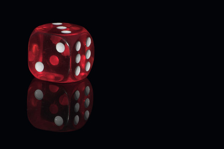 Red casino dice on the black background