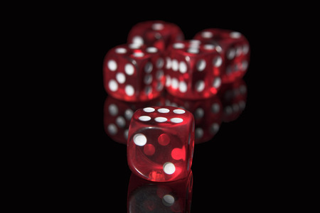 Five red casino dices on the black backgroundの写真素材
