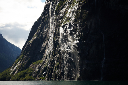 Waterfall in Geirangerfjord in Norway on a sunny dayの写真素材