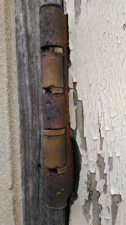 the hinge are rusty  wood door. Doors abandoned house.