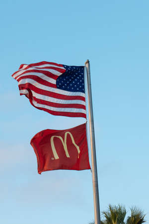 McDonalds restaurants flag and USA national flag against the skyのeditorial素材