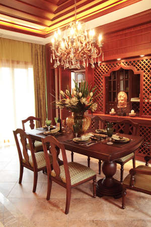 Table in restaurant prepared for dinner by windowの写真素材