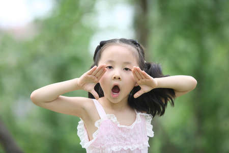 little girl playing in the park, taken in June.の写真素材