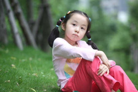 children on the grass, shot in 2011, locations in chinaの写真素材