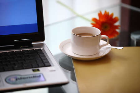 Coffee cup with computers, office casual indoor environment