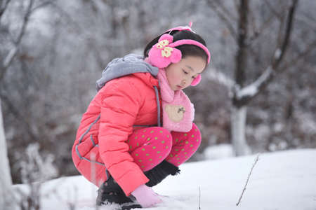 winter girl photos, children playing in the snowの写真素材