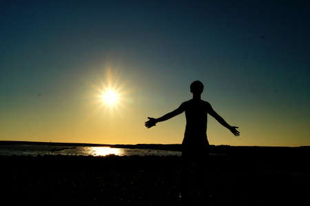 a man want to fly at sunsetの写真素材