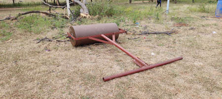 Old broken roller on the ground.の写真素材