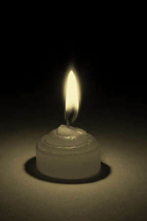 Black dark background, white candles, flame flashes of brilliance の写真素材