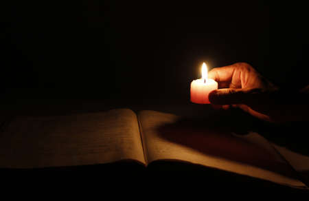 Burning the candle lit the books の写真素材