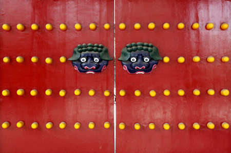 Red Chinese traditional wooden doors on the lion monster and bronze nail 