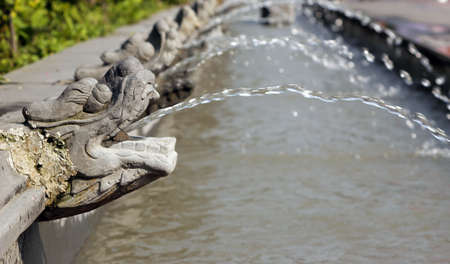 Stone carving out the heads of water park の写真素材